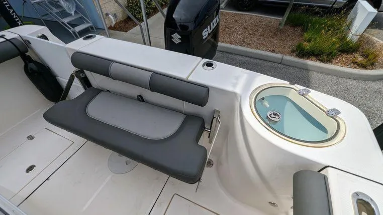 Slide: The Image of 2023 Sea Born SX239 Offshore boat interior with seating and livewell. - 12