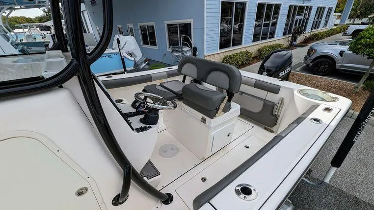 Slide: The Image of 2023 Sea Born SX239 Offshore boat interior with seating and steering console. - 16
