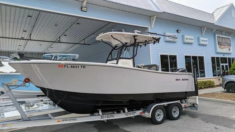 Slide: The Image of 2023 Sea Born SX239 Offshore boat on trailer outside dealership. - 2