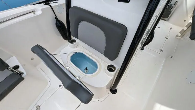 Slide: The Image of 2023 Sea Born SX239 Offshore boat interior with open storage compartment. - 8