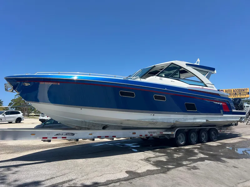 Slide: The Image of 2017 Formula 430 Super Sport Crossover boat on trailer under clear blue sky. - 1