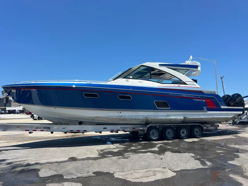 Slide: The Image of 2017 Formula 430 Super Sport Crossover boat on trailer, blue and white design. - 2