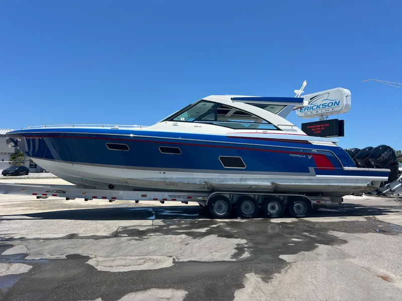 Slide: The Image of 2017 Formula 430 Super Sport Crossover boat on trailer under clear blue sky. - 3
