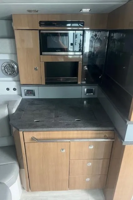 Slide: The Image of 2017 Formula 430 Super Sport Crossover interior with gray leather seating and wood accents. - 30