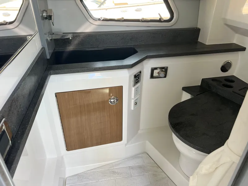 Slide: The Image of 2017 Formula 430 Super Sport Crossover interior kitchen with wood cabinetry and modern appliances. - 32