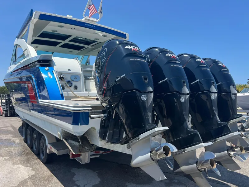 Slide: The Image of 2017 Formula 430 Super Sport Crossover boat on trailer, featuring powerful outboard engines. - 6