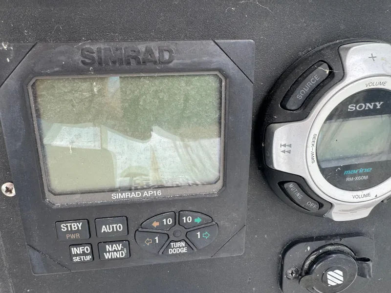 Slide: The Image of Simrad AP16 and Sony marine audio system on 1992 Blackfin 29 Express boat. - 13