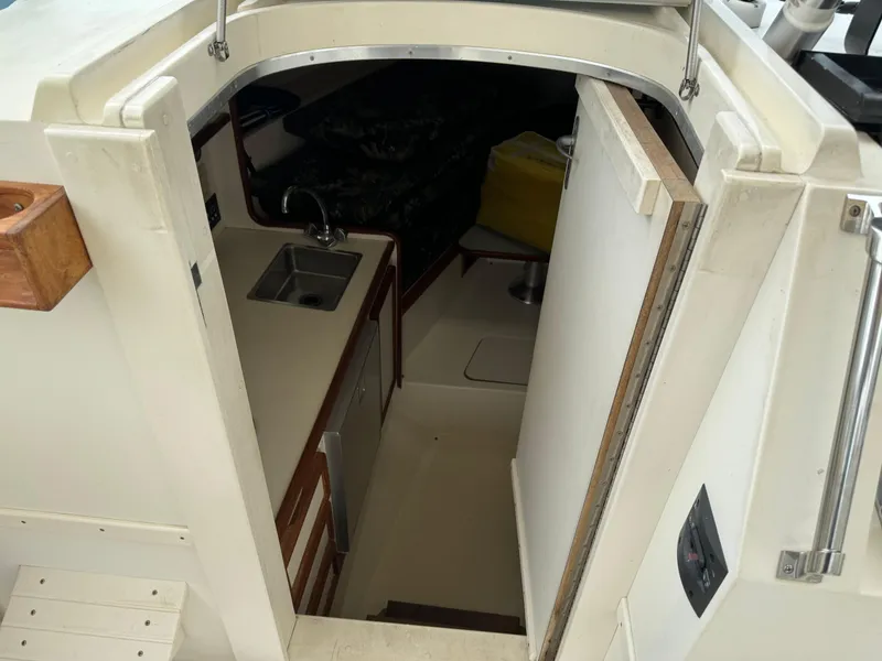 Slide: The Image of Interior view of 1992 Blackfin 29 Express boat showing compact kitchen area. - 14