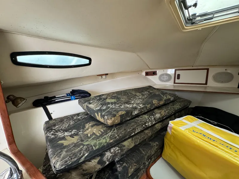 Slide: The Image of Interior cabin of a 1992 Blackfin 29 Express boat with camo cushions and storage. - 18