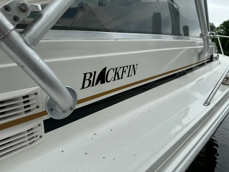 Slide: The Image of 1992 Blackfin 29 Express boat side view with logo. - 2