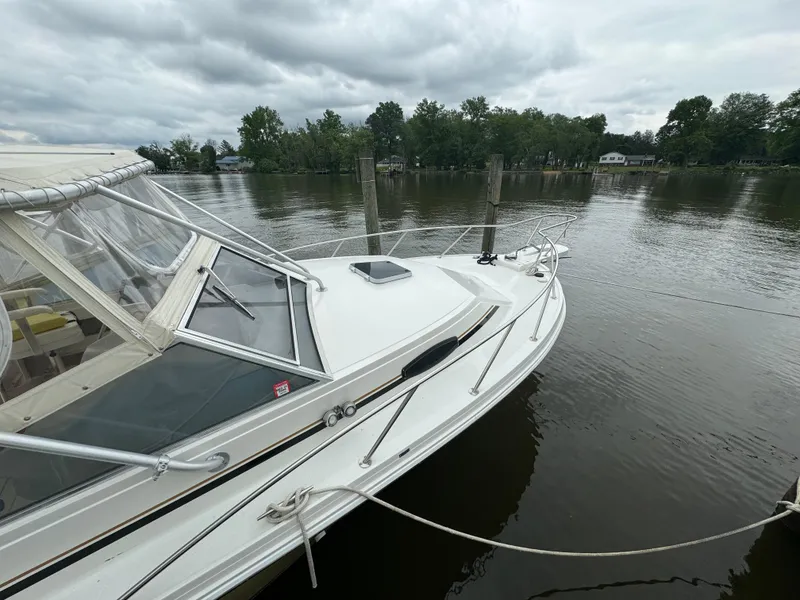 Slide: The Image of 1992 Blackfin 29 Express boat docked on a calm river. - 3