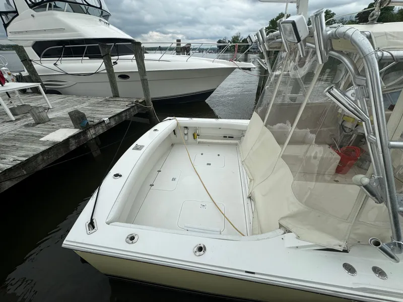 Slide: The Image of 1992 Blackfin 29 Express boat docked at marina, view of spacious deck area. - 4