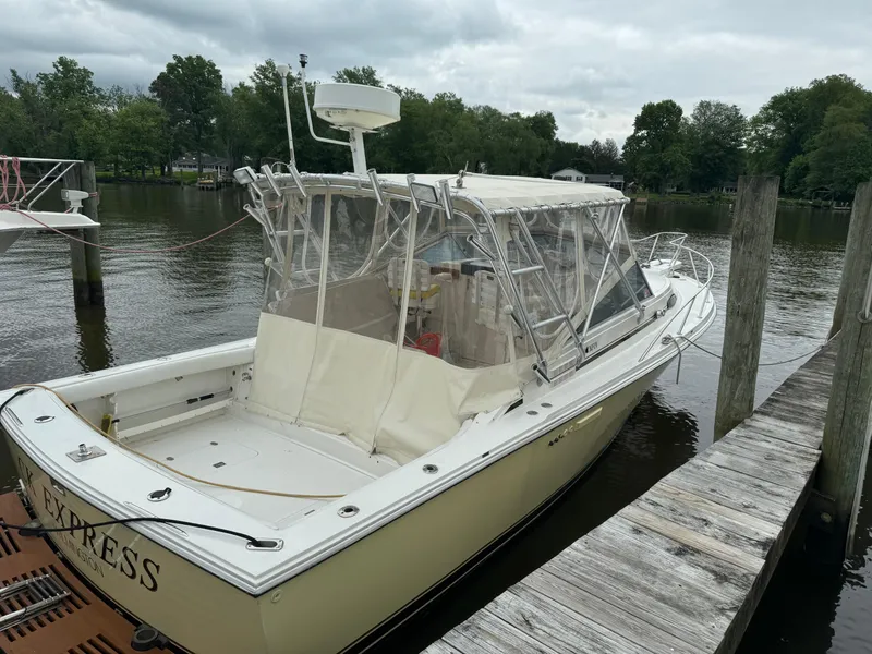 Slide: The Image of 1992 Blackfin 29 Express boat docked by a wooden pier on a cloudy day. - 7