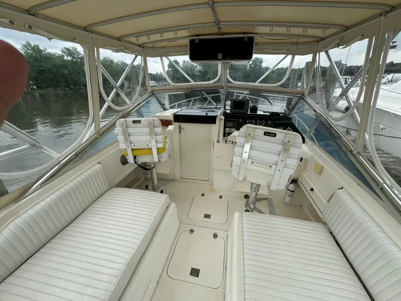 Slide: The Image of 1992 Blackfin 29 Express boat interior with white seating and helm station. - 8
