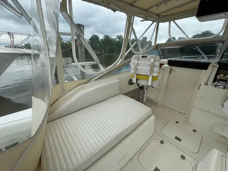 Slide: The Image of 1992 Blackfin 29 Express boat interior with white seating and helm station. - 9