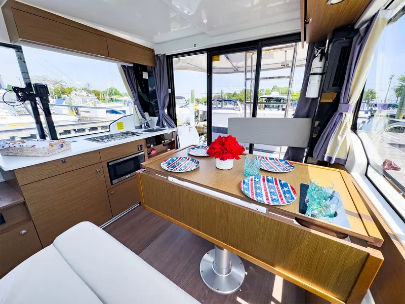 Slide: The Image of Interior of 2021 Jeanneau NC 1095 FLY yacht with dining table set for four. - 11