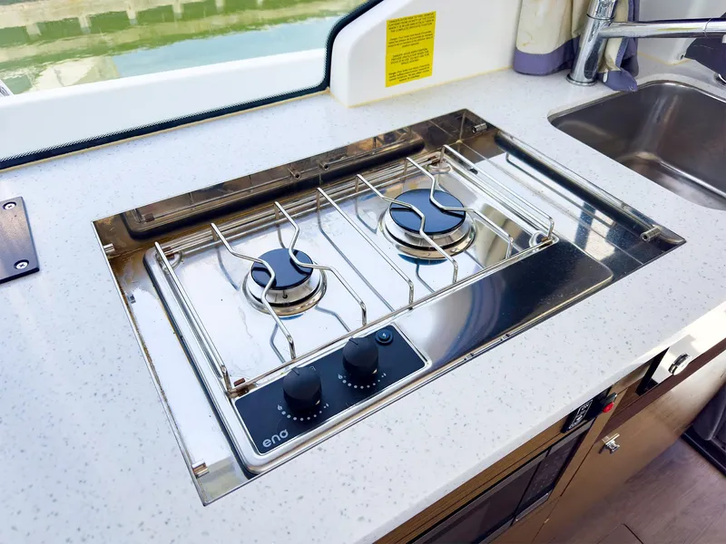 Slide: The Image of Modern kitchen stove on the 2021 Jeanneau NC 1095 FLY boat. - 16