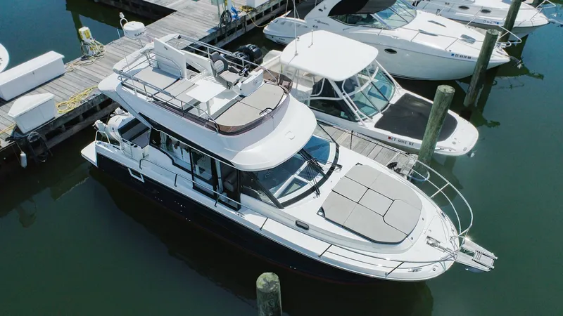 Slide: The Image of 2021 Jeanneau NC 1095 FLY docked at marina, aerial view. - 2