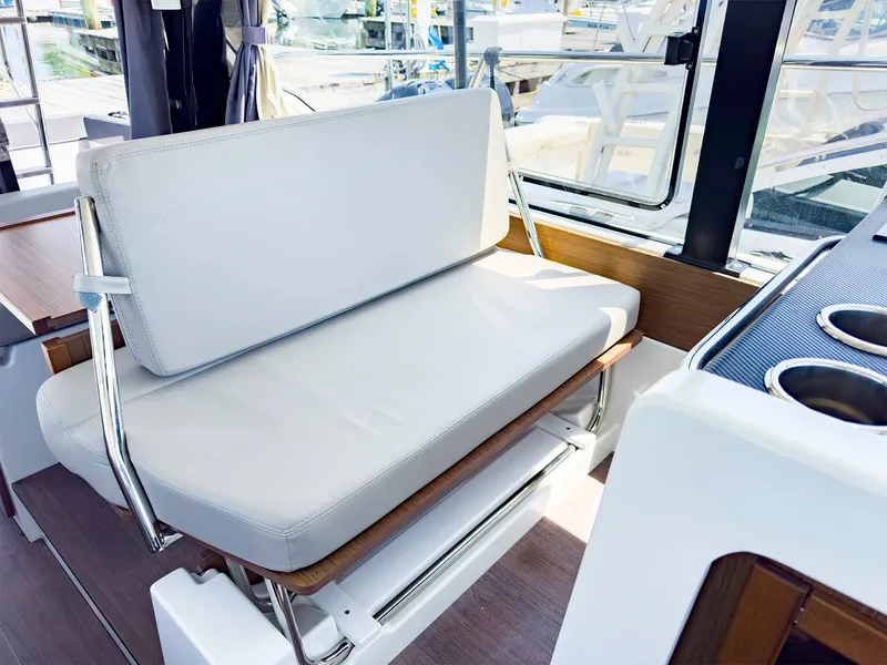 Slide: The Image of Interior seating of 2021 Jeanneau NC 1095 FLY boat with white cushions. - 22