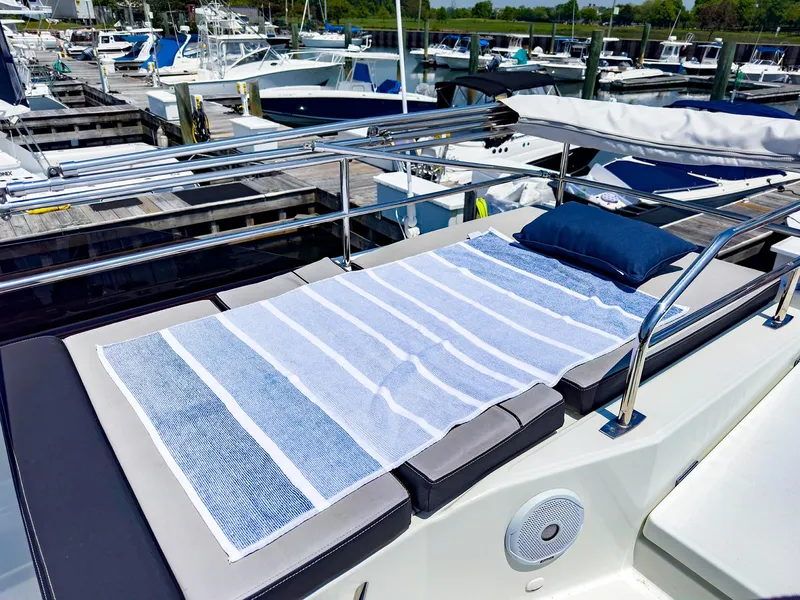 Slide: The Image of Sunbathing deck on a 2021 Jeanneau NC 1095 FLY yacht at a marina. - 28