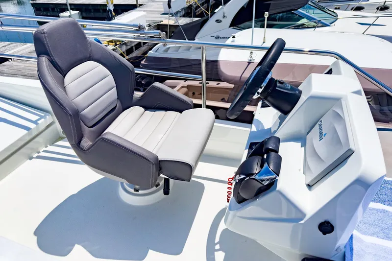 Slide: The Image of Captain's chair and helm of 2021 Jeanneau NC 1095 FLY boat at marina. - 31