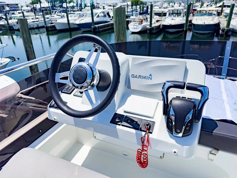 Slide: The Image of 2021 Jeanneau NC 1095 FLY helm with Garmin navigation system at marina. - 32