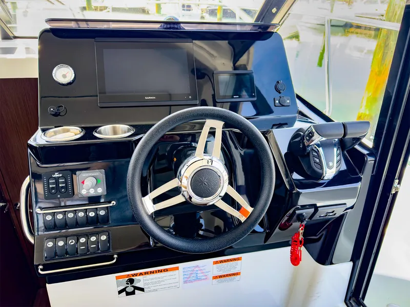 Slide: The Image of Helm station of 2021 Jeanneau NC 1095 FLY with steering wheel and control panel. - 4