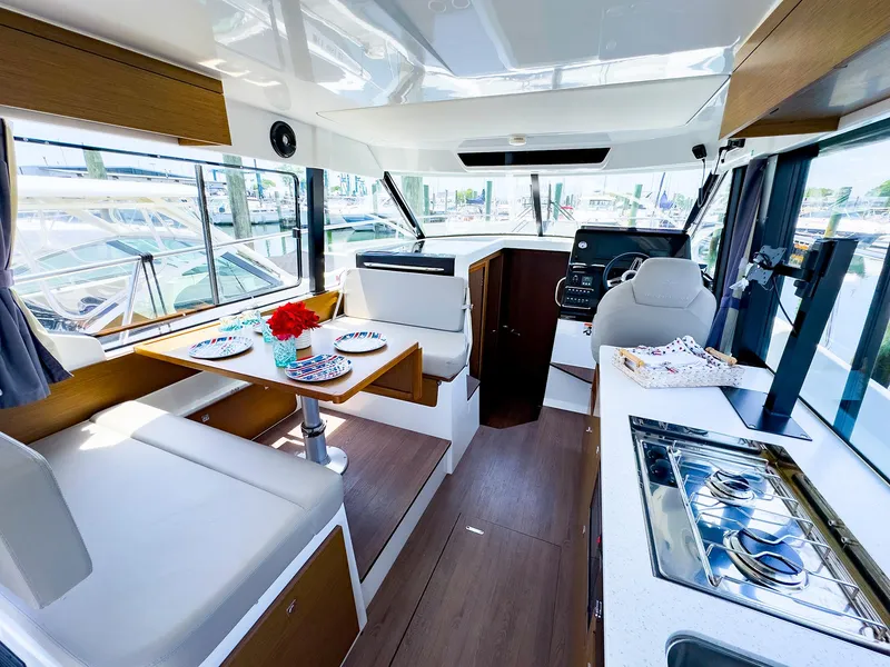 Slide: The Image of Interior of 2021 Jeanneau NC 1095 FLY boat with dining area and kitchen. - 8