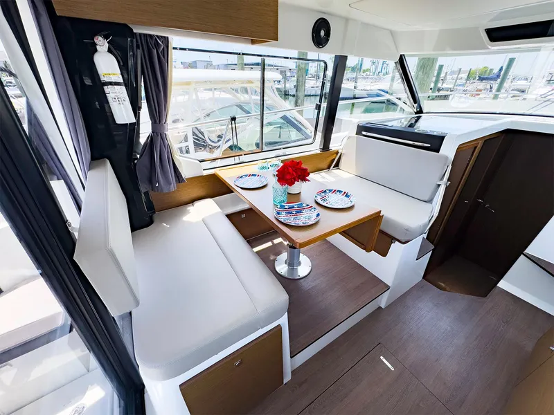 Slide: The Image of Interior of 2021 Jeanneau NC 1095 FLY boat with dining area and windows. - 9