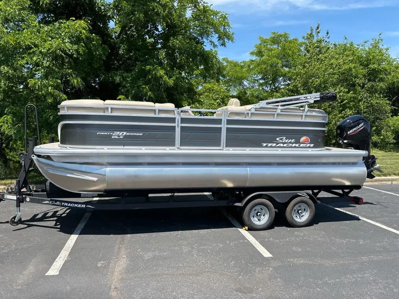 Slide: The Image of 2024 Sun Tracker Party Barge 20 DLX pontoon boat parked in a lot. - 6