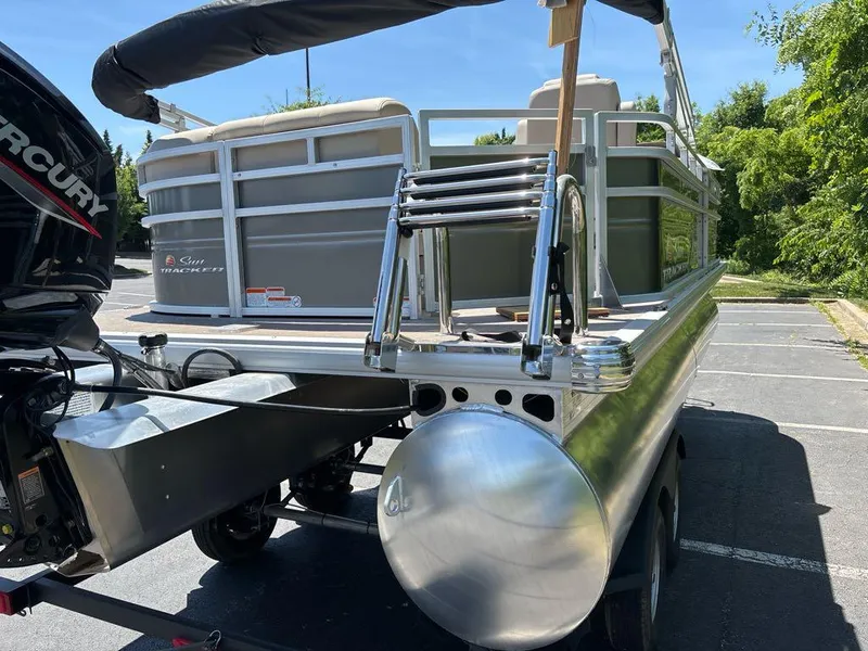 Slide: The Image of 2024 Sun Tracker Party Barge 20 DLX pontoon boat in a parking lot. - 9