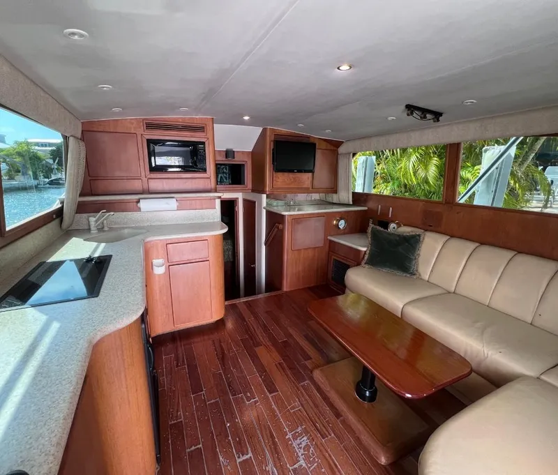 Slide: The Image of Interior of 2001 Egg Harbor 37 Convertible yacht with modern kitchen and cozy seating area. - 10