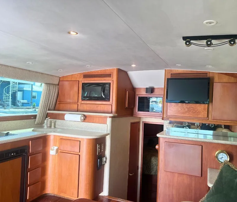 Slide: The Image of Interior of 2001 Egg Harbor 37 Convertible yacht with modern kitchen and entertainment area. - 11