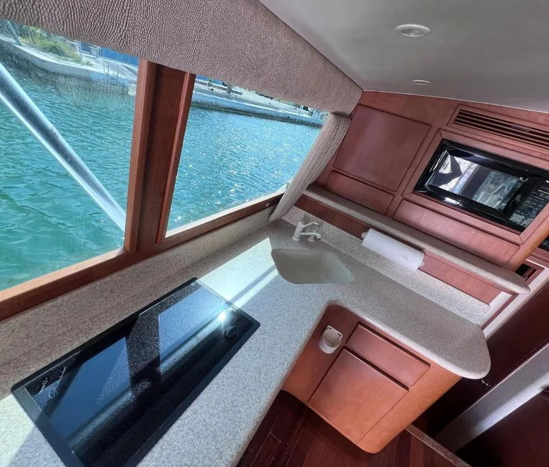 Slide: The Image of Interior of 2001 Egg Harbor 37 Convertible yacht with kitchen and waterfront view. - 12