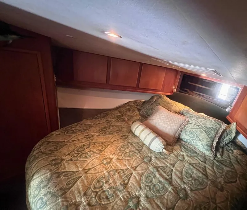 Slide: The Image of Luxurious bedroom in a 2001 Egg Harbor 37 Convertible yacht. - 17