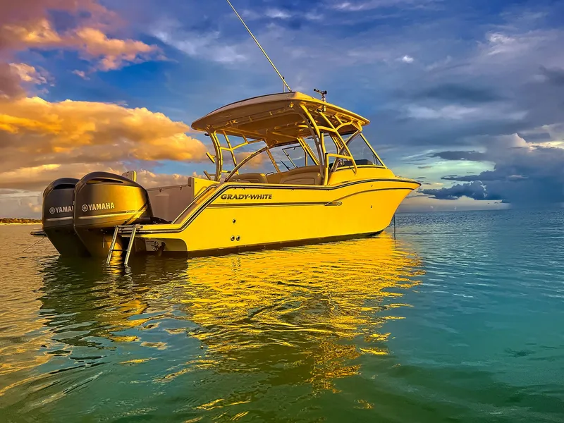 Slide: The Image of 2018 Grady-White Freedom 335 boat on calm water at sunset. - 1