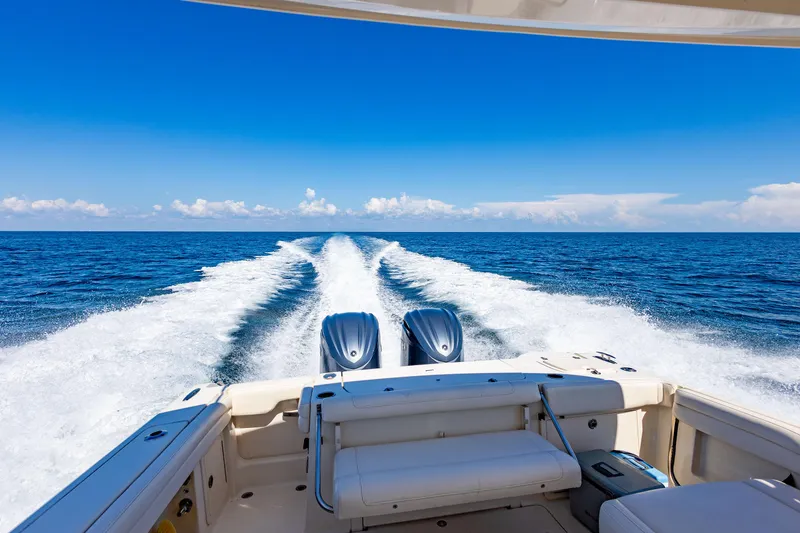 Slide: The Image of 2018 Grady-White Freedom 335 boat cruising on open ocean. - 11