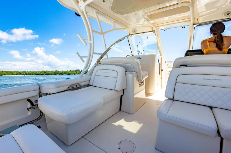 Slide: The Image of 2018 Grady-White Freedom 335 boat interior with white seating and ocean view. - 9