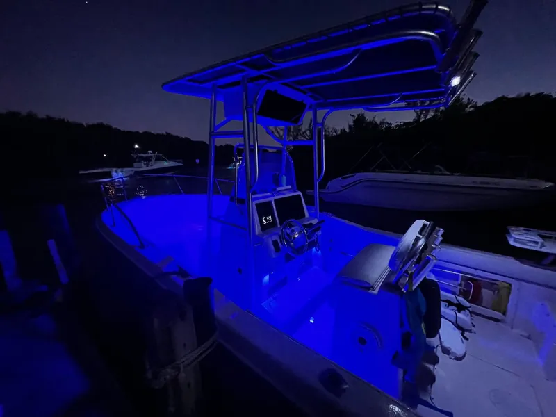 Slide: The Image of 1999 Grady-White 209 ESCAPE boat illuminated with blue LED lights at night. - 13