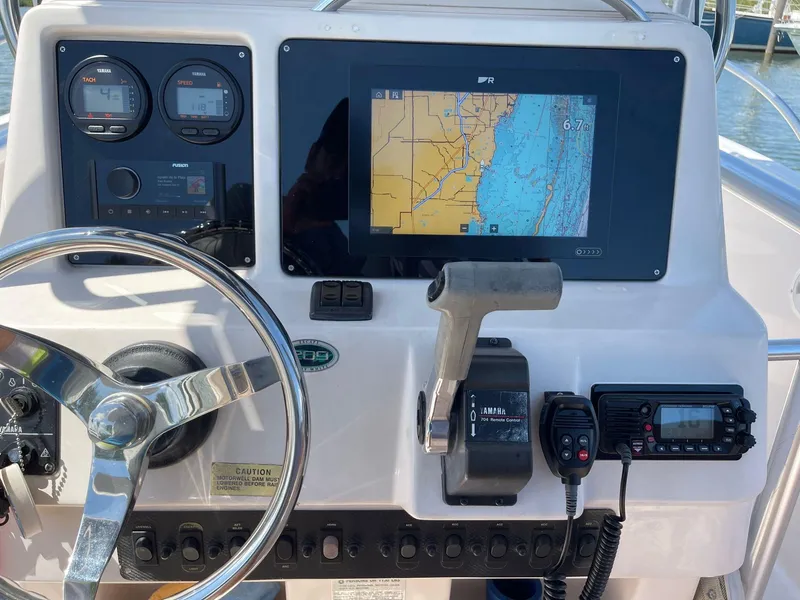 Slide: The Image of 1999 Grady-White 209 ESCAPE boat dashboard with GPS, steering wheel, and control panel. - 14