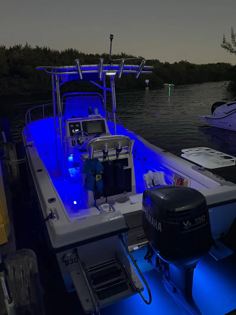 Slide: The Image of 1999 Grady-White 209 ESCAPE boat with blue LED lights docked at night. - 15