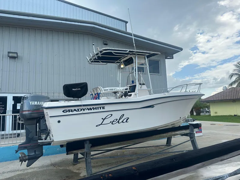 Slide: The Image of 1999 Grady-White 209 ESCAPE boat on a trailer, named Lela, with Yamaha outboard motor. - 7