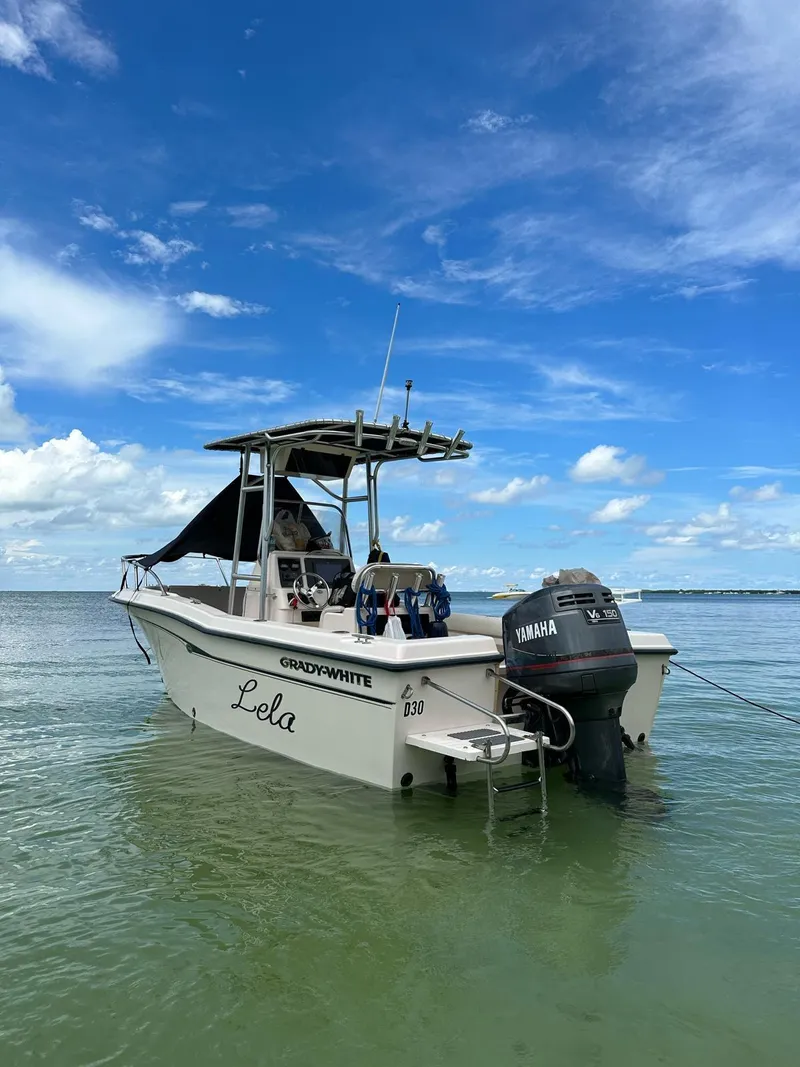 Slide: The Image of Grady-White 209 ESCAPE 1999 boat anchored in calm waters under a clear blue sky. - 8