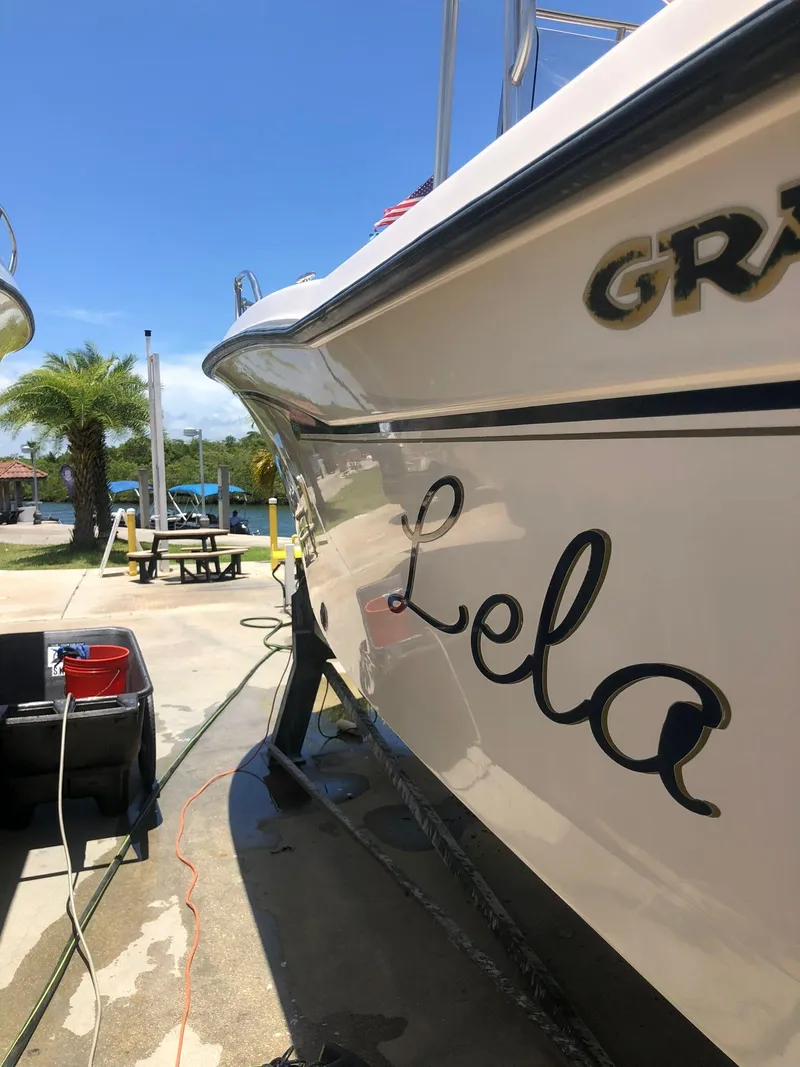 Slide: The Image of 1999 Grady-White 209 ESCAPE boat named Lela docked and being cleaned. - 9