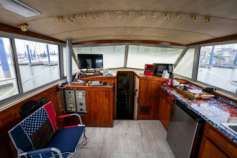 Slide: The Image of Interior of 1984 Bertram 33 Sport Fisherman boat with control panel and kitchenette. - 11