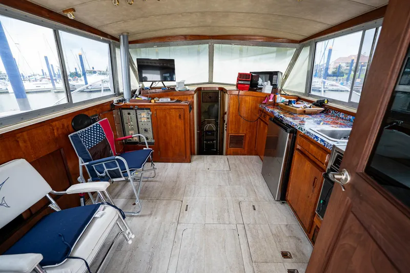 Slide: The Image of Interior of 1984 Bertram 33 Sport Fisherman boat with wooden cabinetry and seating. - 12