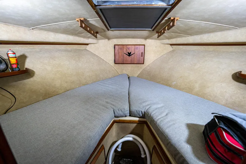 Slide: The Image of 1984 Bertram 33 Sport Fisherman cabin interior with twin beds and storage. - 19