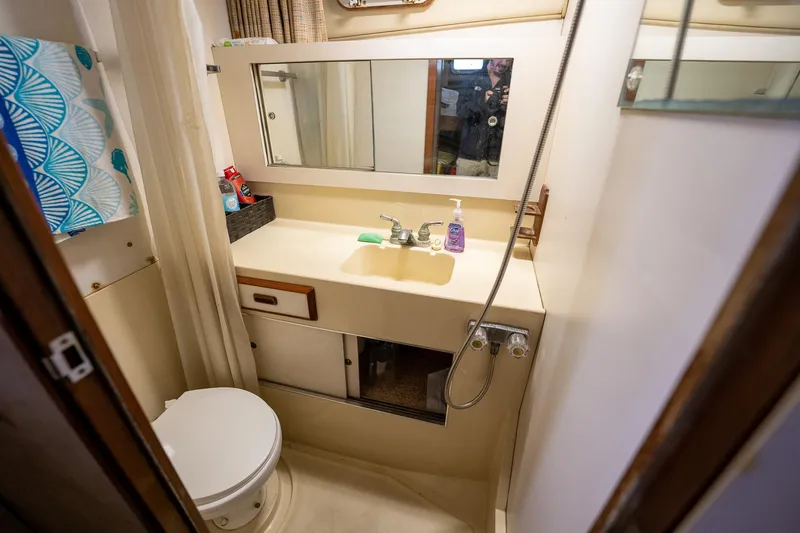 Slide: The Image of 1984 Bertram 33 Sport Fisherman boat bathroom with sink, mirror, and toilet. - 20