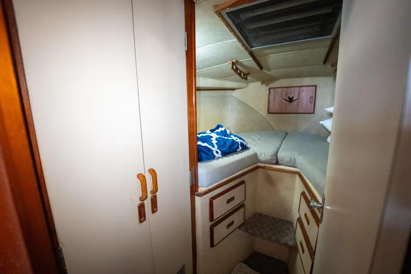 Slide: The Image of 1984 Bertram 33 Sport Fisherman cabin interior with bed, storage, and closet. - 24