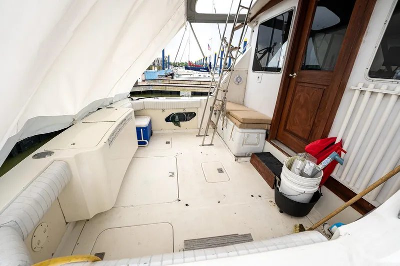 Slide: The Image of 1984 Bertram 33 Sport Fisherman boat deck with seating and storage. - 6